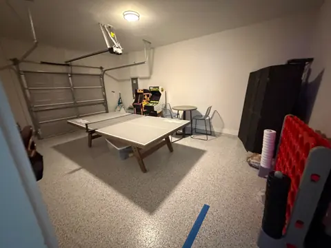Games room with a table tennis table, arcade machines and organized seating